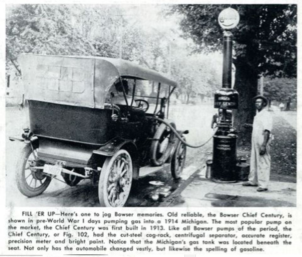 Pumping gasoline into a 1914 Michigan automobile